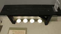 a black bench with four lights on it
