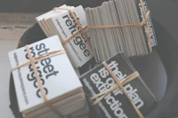 a stack of business cards in a hat