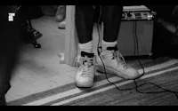 a black and white photo of a pair of white sneakers
